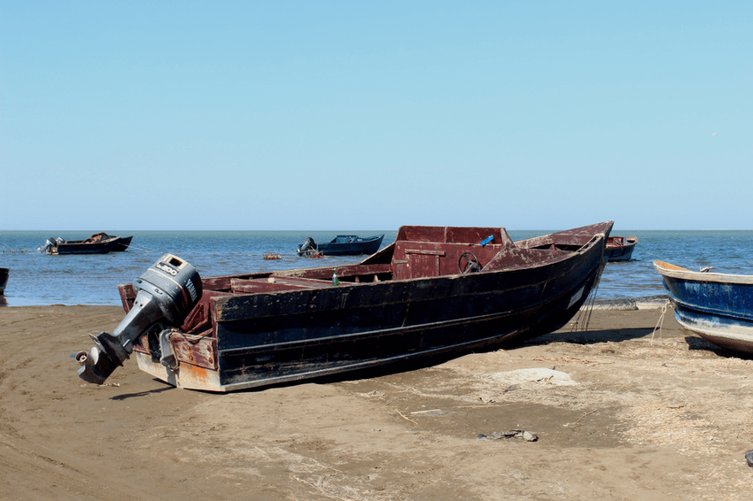 Small wood fishing boat with a large motor attached.